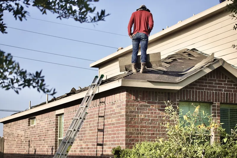 Professional roofer working on a residential roof in Smithfield